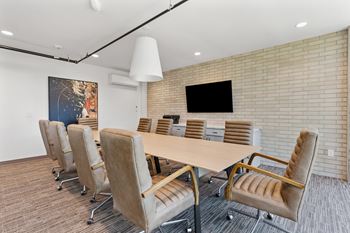 A conference room with a screen on wall
